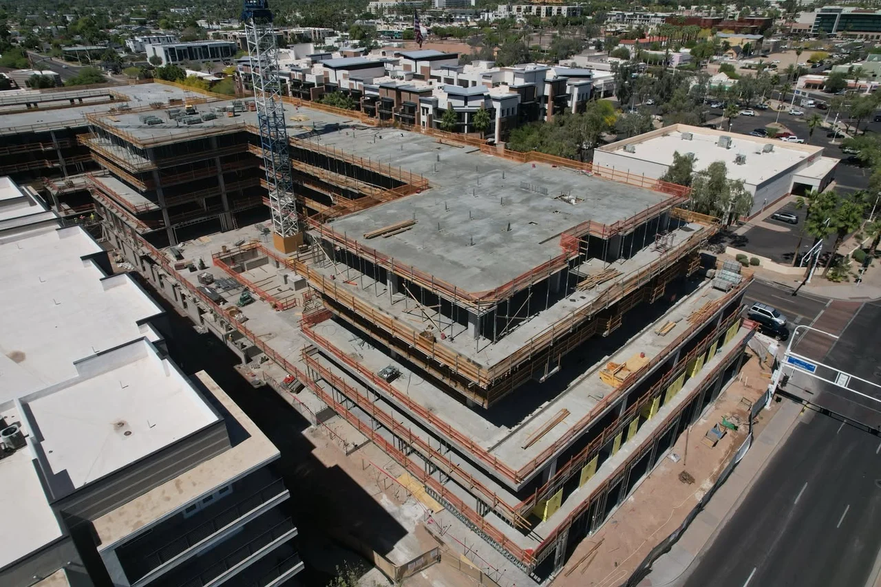 Aerial construction view of exposed concrete slabs, columns and stepped floor plates at The Monroe in Old Town Scottsdale