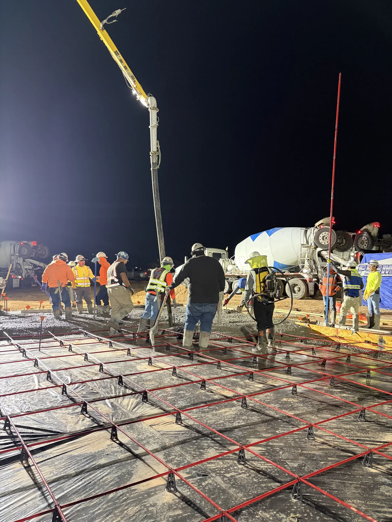 Method crew placing concrete under work lights at Touchstone at Superstition Vistas